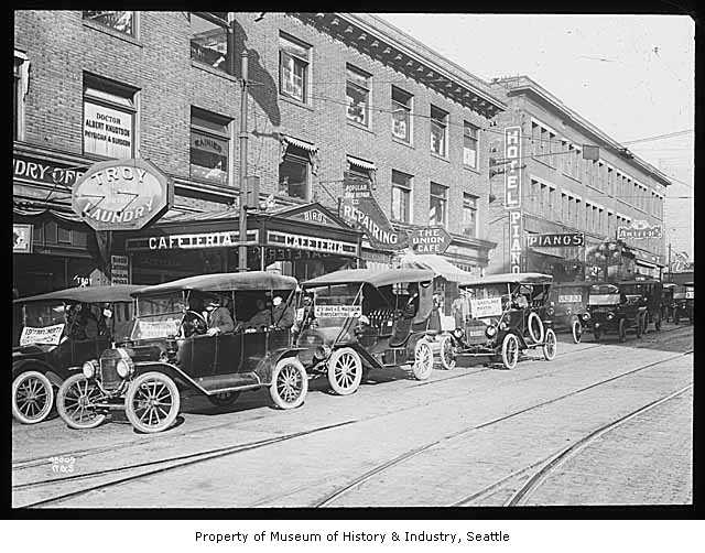 Jitney buses lined up on street, Seattle, 1918