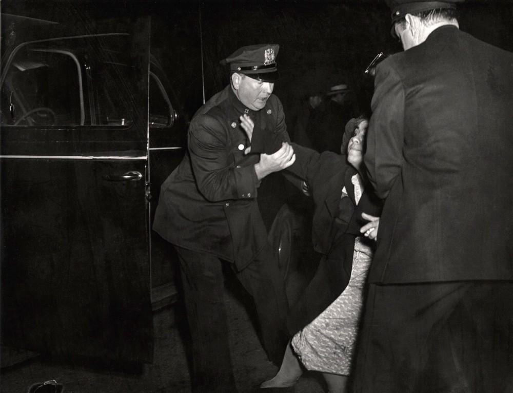 Weegee - The dead man's wife arrived, and she collapsed, ca. 1940
