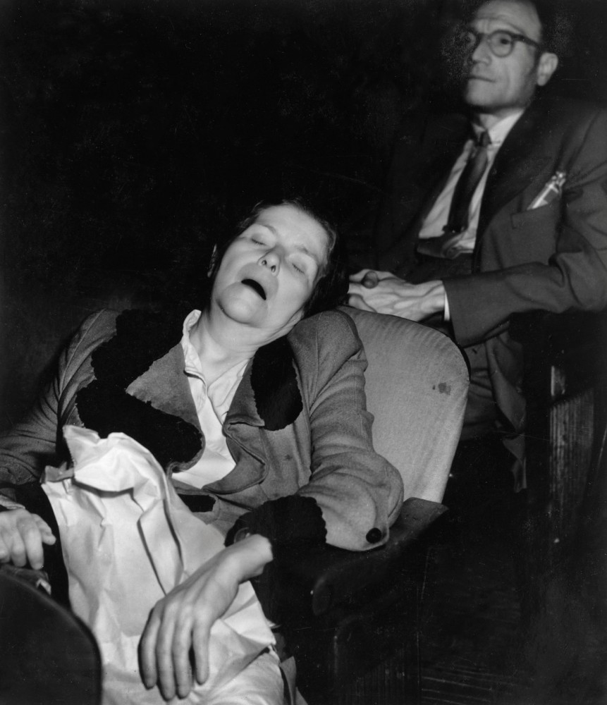 Weegee - Woman sleeping in movie theater, ca. 1943